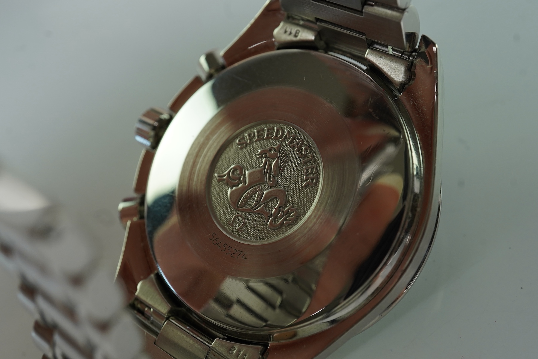 A gentleman's late 1990's stainless steel Omega Speedmaster automatic wrist watch, with box and three pamphlets